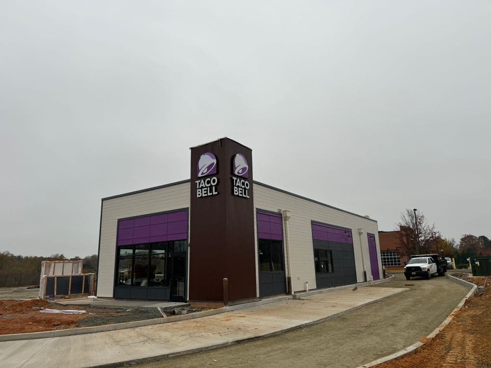 New Taco Bell restaurant building under construction on a cloudy day.